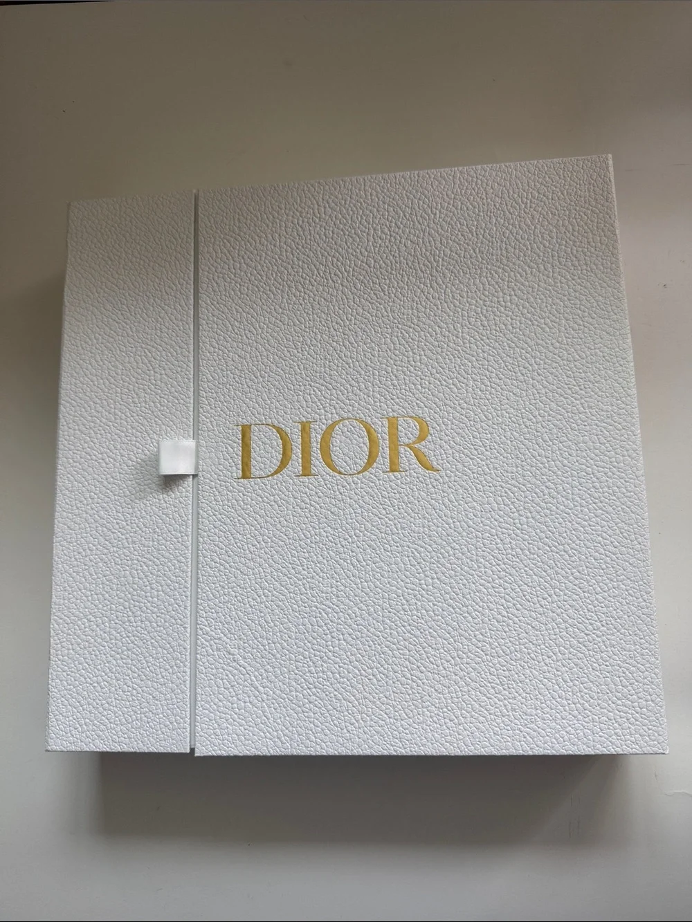 A Large Textured Christian Dior Gold Logo Gift Box With Ribbon Side Closure